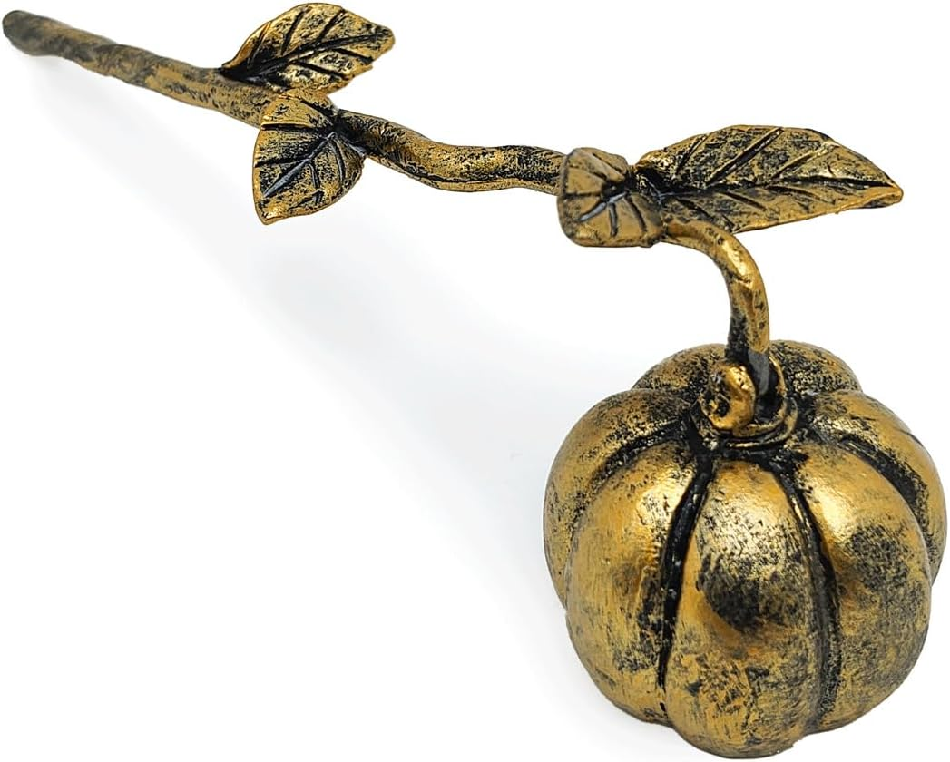 A decorative brass pumpkin and vine holder with a textured metallic finish, shown on a plain white background.