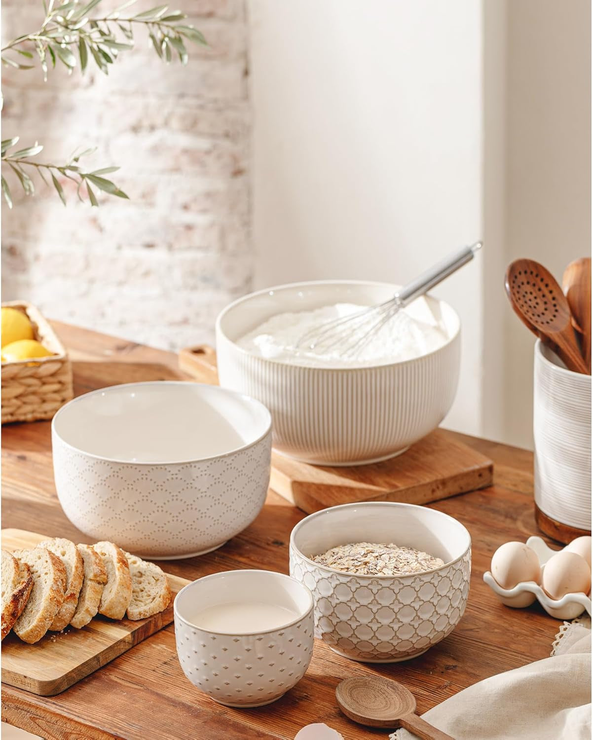 Embossed ceramic mixing bowls used for baking and food preparation in a farmhouse kitchen.
