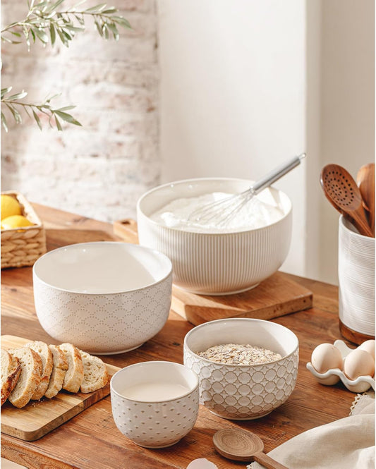 Embossed ceramic mixing bowls used for baking and food preparation in a farmhouse kitchen.