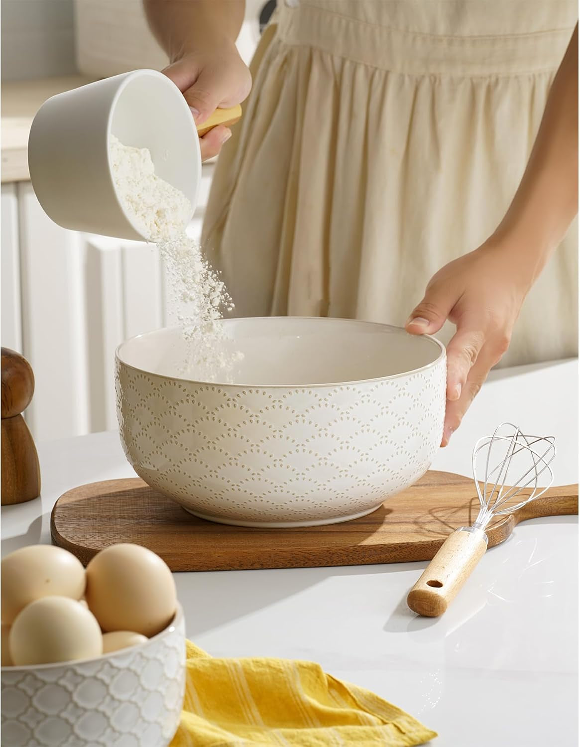 Embossed ceramic mixing bowl used for mixing baking ingredients.