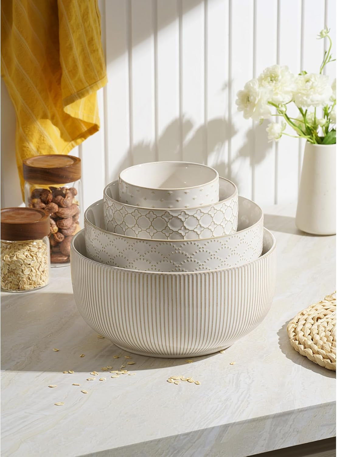 Nesting ceramic mixing bowls stacked together for compact kitchen storage.